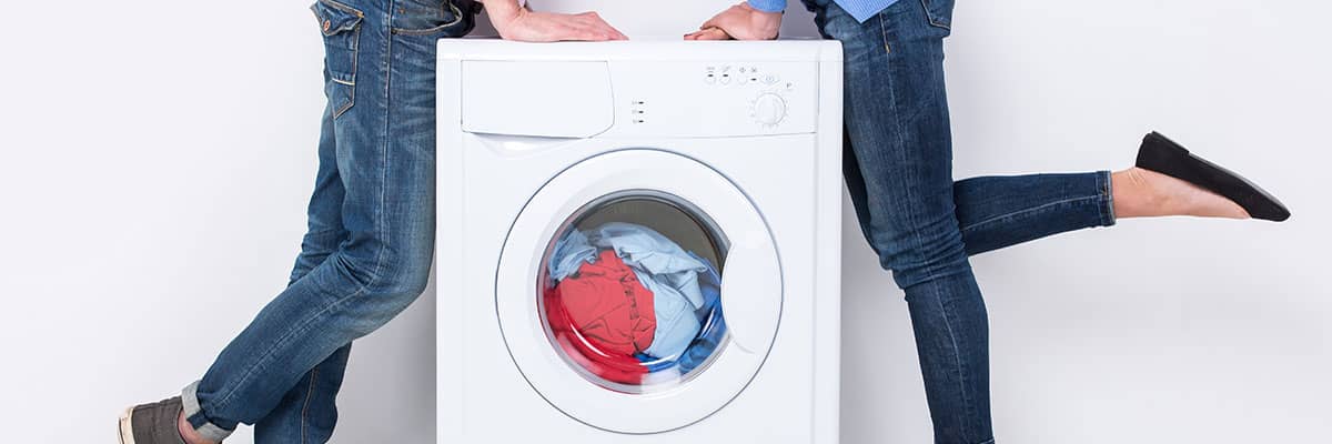 Energie sparen: Paar an einer energieeffizienten Waschmaschine