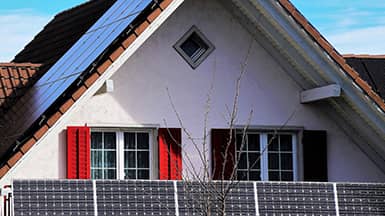 Erneuerbare Energie: Haus mit Photovoltaikanlage an der Fassade
